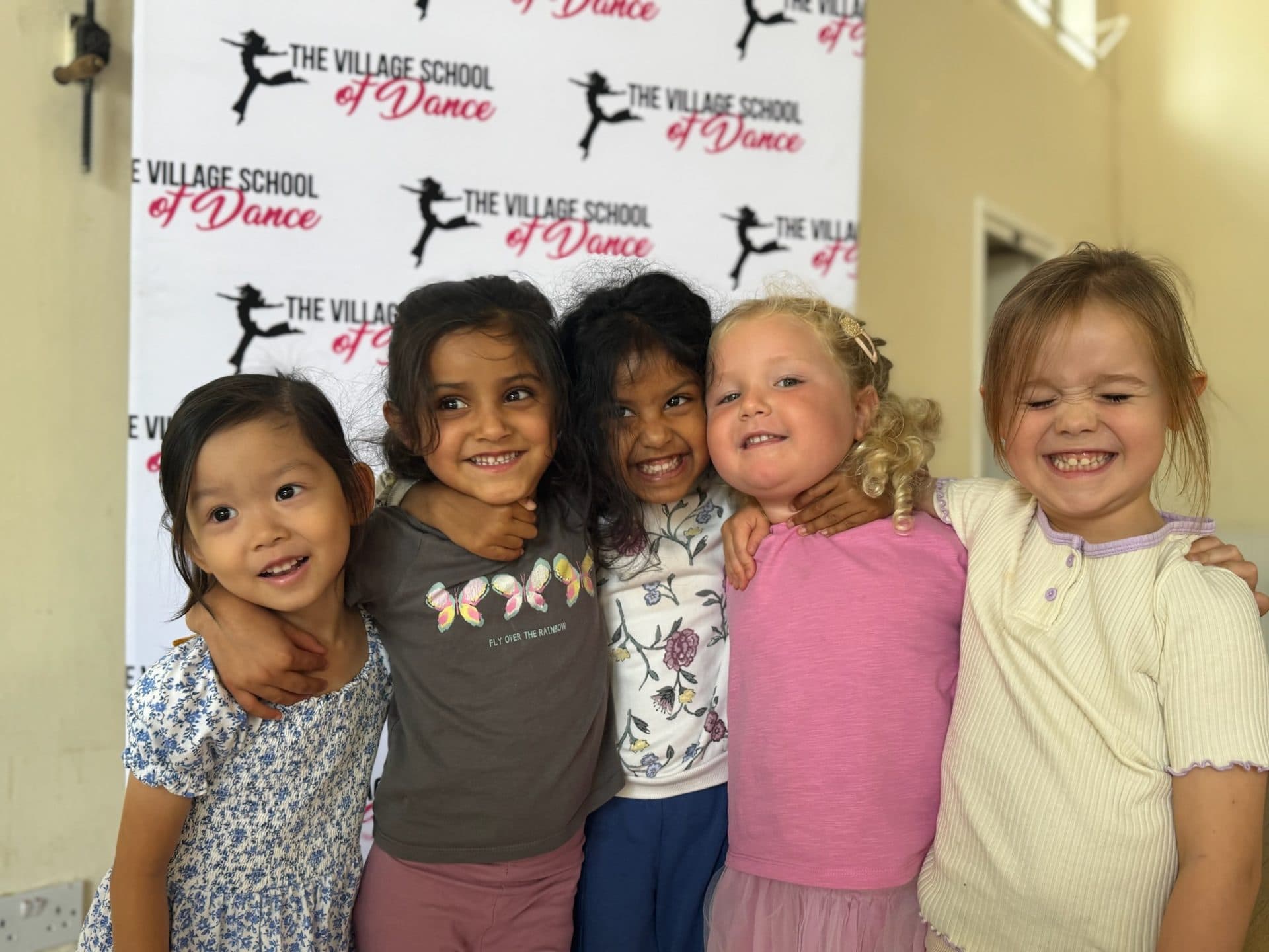 Friends hugging at a Village School holiday camp