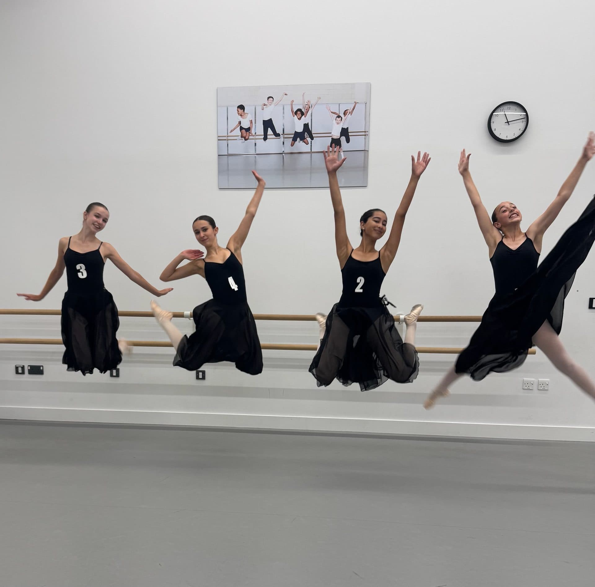 Students jumping together in class at The Village School of Dance in Wimbledon