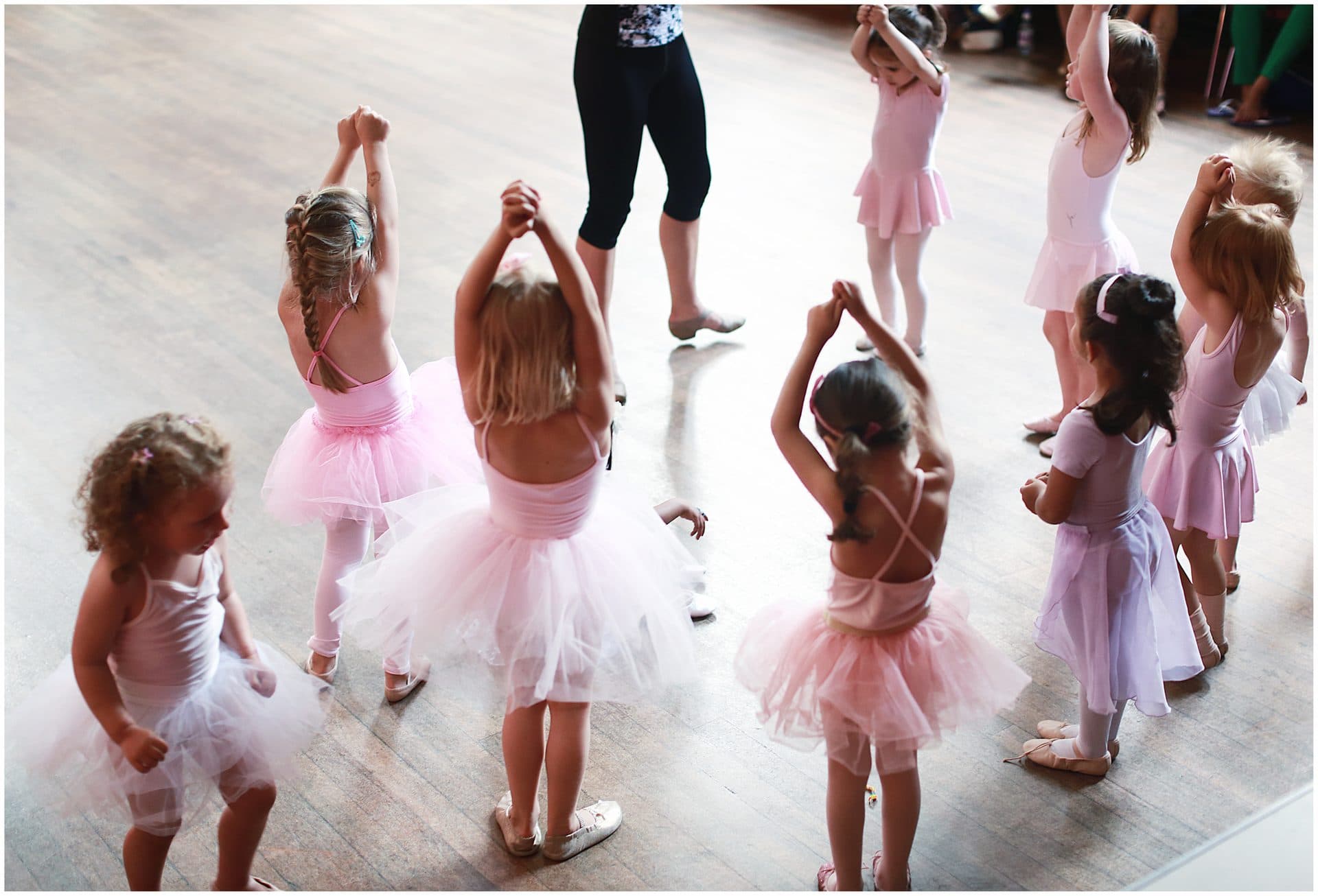 Pre-school ballerinas in pink tutus standing in a circle